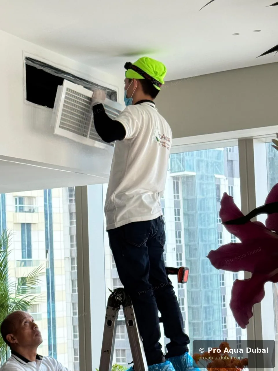 Two Pro Aqua technicians cleaning AC ducts in Dubai high-rise apartment